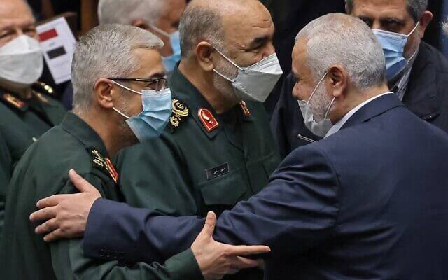 The leader of the Palestinian Hamas movement, Ismail Haniyeh (2nd R), shakes hands with Iranian Chief of Staff for the Armed Forces Mohammad Bagheri (L) and the commander of Iran's Revolutionary Guard force, General Hossein Salami (C), during the swearing in ceremony for Iran's new president at the parliament in the Islamic republic's capital Tehran on August 5, 2021. (Atta KENARE / AFP)