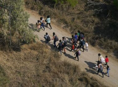 Migrants walk on a dirt road after crossing the U.S.-Mexico border, Tuesday, March 23, 2021, in Mission, Texas. Julio Cortez / AP Photo