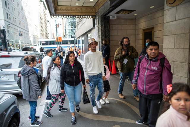 Asylum seekers arrive to the Roosevelt Hotel on Friday, May 19, 2023, in New York. The historic hotel in midtown Manhattan shuttered three years ago, will accommodate an anticipated influx of asylum seekers just as other New York City hotels are being converted to emergency shelters. (AP Photo/Eduardo Munoz Alvarez)