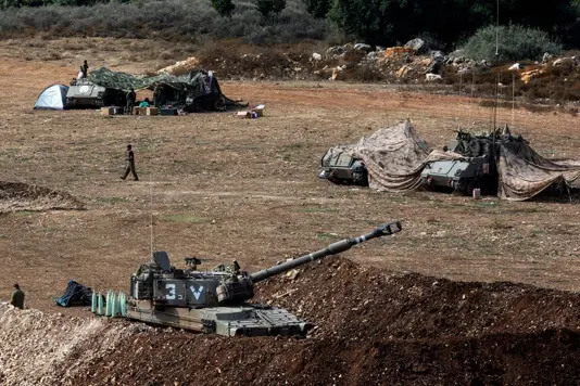 An Israeli tank and military vehicles near Israel's border with Lebanon, northern Israel. Reuters