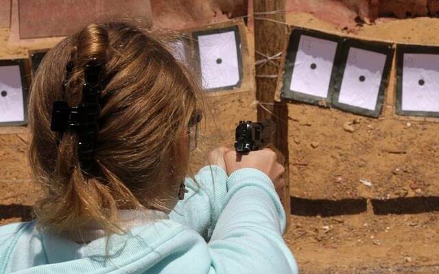 A girl shooting a pistol at a shooting range in Gush Etzion. Nati Shohat/Flash90