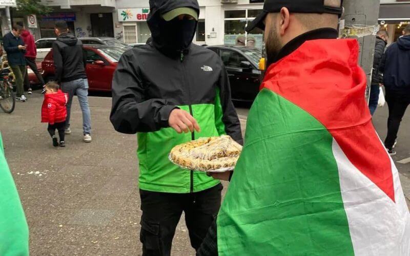 In the Neukölln district of Berlin, members of the pro-Palestinian organization Samidoun distribute sweets to passers-by to 'celebrate the victory' of the Oct. 7 Hamas attack. Reddit