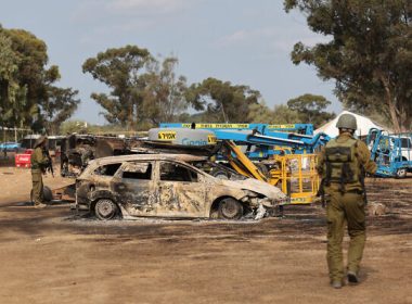 Israeli troops inspect the ravaged site of the weekend attack on the Supernova desert music Festival by Palestinian gunmen near Kibbutz Re’im in the Negev desert in southern Israel on October 10, 2023. AFP