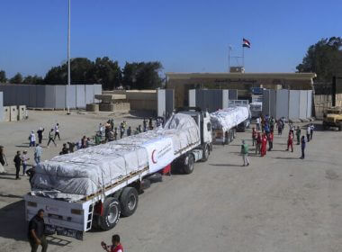 Trucks of Egyptian Red Crescent carrying humanitarian aid for the Gaza Strip cross the Rafah border gate, in Rafah, Egypt. Mohammed Asad/AP