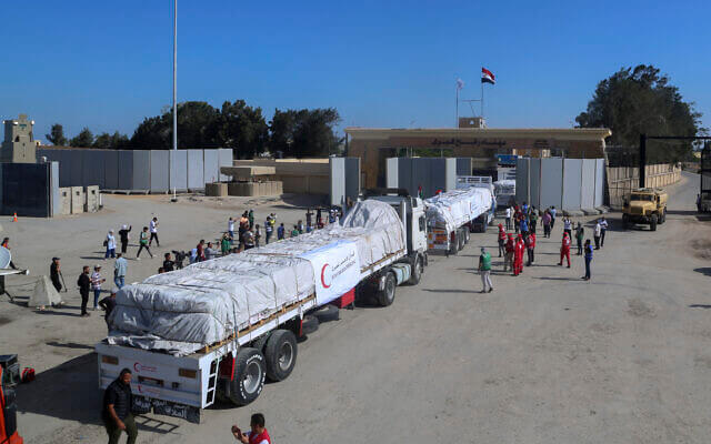 Trucks of Egyptian Red Crescent carrying humanitarian aid for the Gaza Strip cross the Rafah border gate, in Rafah, Egypt. Mohammed Asad/AP