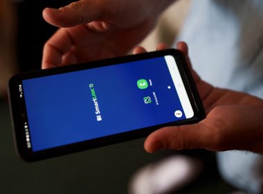 A migrant shows the phone he was given to take photos of himself for check-ins with Immigration and Customs Enforcement in Deming, New Mexico, March 31, 2022. REUTERS/Paul Ratje