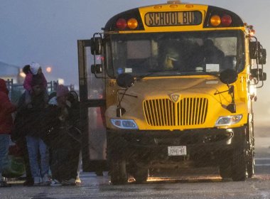 Nearly 2,000 migrants are evacuated by school buses from tents at Floyd Bennett Field to a local high school in preparation for a storm with estimated wind speeds to be more than 70 mph. ((Photo by Spencer Platt/Getty Images))