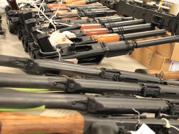 Guns, handguns, AK-47s and .50 caliber rifles, on display during an announcement about arrests and weapons seizures made during Operation Fast and Furious. Shutterstock