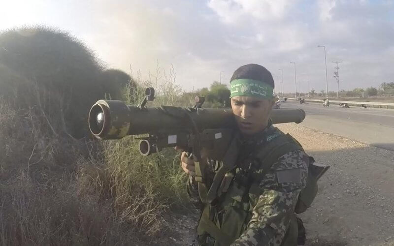 In this image from a body camera video during the Oct. 7, 2023, attack on Israel, a Hamas member holds a Russian-designed Strela anti-aircraft missile. South First Responders