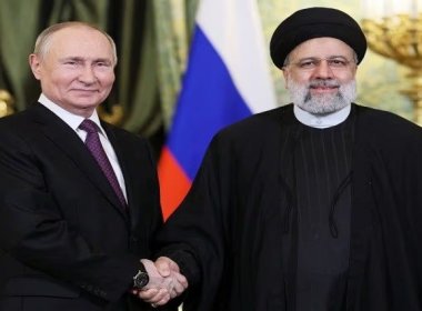 Russian President Vladimir Putin shakes hands with Iranian President Ebrahim Raisi during a meeting. Reuters