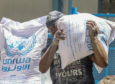 Palestinians receive their monthly food rations from the United Nations Relief and Works Agency (UNRWA) warehouse in Khan Younis in the southern Gaza Strip on June 14, 2022. (Photo by SAID KHATIB / AFP)