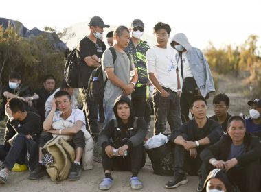 Migrants from China wait to be processed by U.S. Border Patrol agents near Jacumba Hot Springs. (Denis Poroy / For The San Diego Union-Tribune)