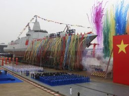 Fireworks explode next to China's new domestically built 10,000-ton Type 055 destroyer during a launching ceremony at Jiangnan Shipyard in Shanghai, China, AP