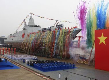 Fireworks explode next to China's new domestically built 10,000-ton Type 055 destroyer during a launching ceremony at Jiangnan Shipyard in Shanghai, China, AP