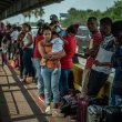 Migrants waiting to cross the border at Brownsville, Texas, in May. Some migrants have been sent to cities throughout the country on buses chartered by Texas Gov. Greg Abbott. The New York Times