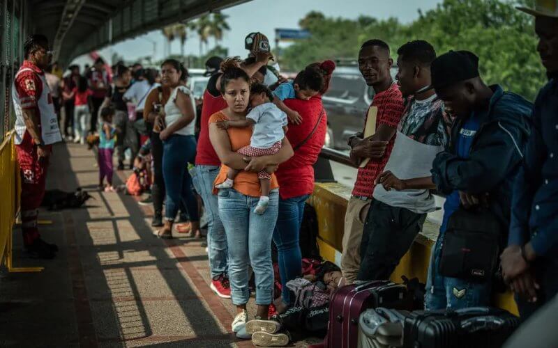 Migrants waiting to cross the border at Brownsville, Texas, in May. Some migrants have been sent to cities throughout the country on buses chartered by Texas Gov. Greg Abbott. The New York Times