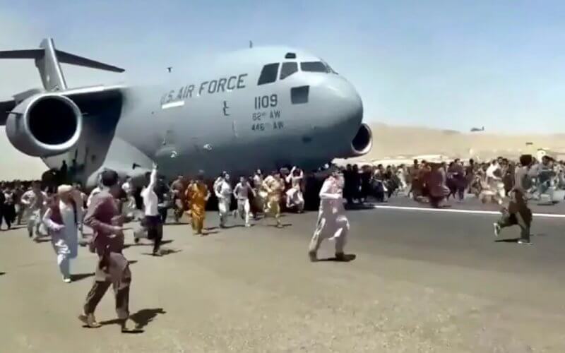 Desperate to flee, Afghans ran alongside a U.S. military plane in Kabul. AP