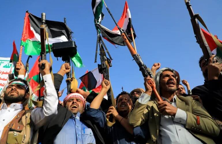 People brandish rifles and Palestinian flags in the Yemeni capital Sanaa. AFP