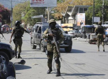 Members of the General Security Unit of the National Palace, USGPN, set up a security perimeter around one of the three downtown stations after police fought off an attack by gangs the day before, in Port-au-Prince, Haiti, Saturday, March 9, 2024. AP