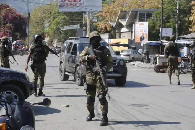 Members of the General Security Unit of the National Palace, USGPN, set up a security perimeter around one of the three downtown stations after police fought off an attack by gangs the day before, in Port-au-Prince, Haiti, Saturday, March 9, 2024. AP