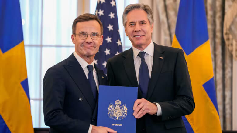 Secretary of State Antony Blinken, right, poses for a photo with Swedish Prime Minister Ulf Kristersson holding Sweden's NATO Instruments of Accession in the Benjamin Franklin Room at the State Department, on Thursday in Washington. AP