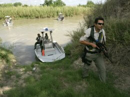 Border Patrol agents inspect a potential landing spot for illegal immigrants along the Rio Grande River in Texas. U.S. Customs and Border Protection