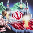A man walks past a banner depicting missiles launching from a representation of the map of Iran colored with the Iranian flag in central Tehran on April 15, 2024. (ATTA KENARE / AFP)