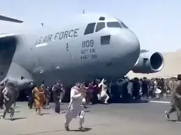 Afghans run alongside a C-17 Globemaster III transport aircraft at Hamid Karzai International Airport in Kabul on August 16, 2021. twitter.com