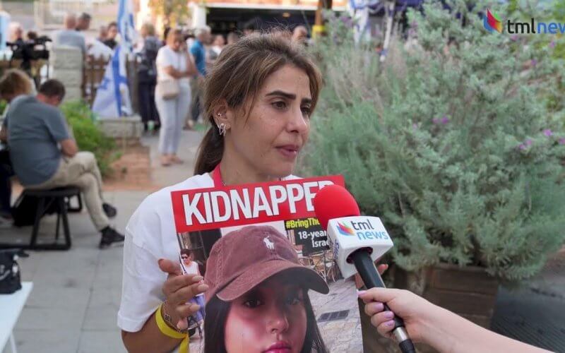 Liri Albag's mother holds a picture of the captured soldier. youtube.com
