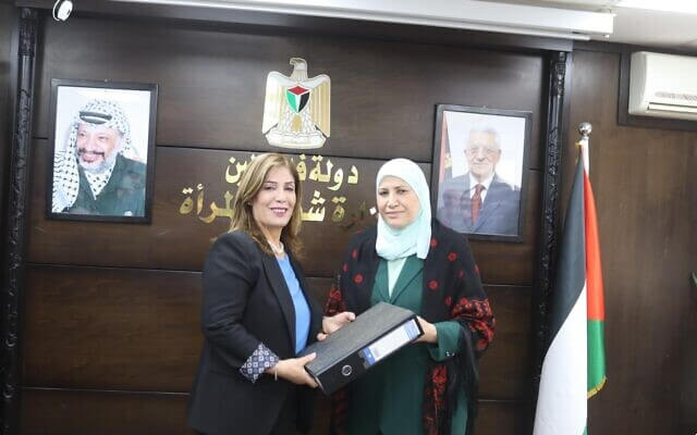 Palestinian Minister of Women’s Affairs Mona Khalili (L) assumes her portfolio from her predecessor Amal Hamad in Ramallah, April 1, 2024 (Palestinian News Agency WAFA)