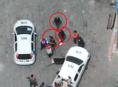 Gunmen next to U.N. vehicles at a UNRWA logistics center Rafah. IDF