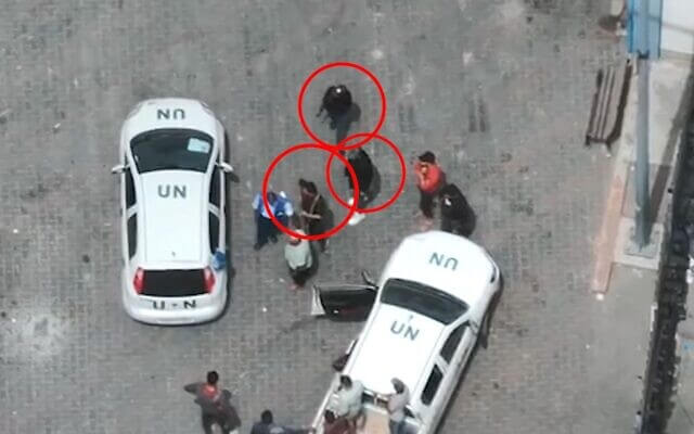 Gunmen next to U.N. vehicles at a UNRWA logistics center Rafah. IDF