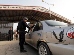 A Jordanian policeman checks a car at Jordan's Jaber border crossing checkpoint near Syria's Nasib checkpoint. Reuters