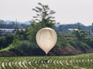 A balloon believed to have been sent by North Korea, carrying various objects including what appeared to be trash and excrement, is seen over a rice field at Cheorwon, South Korea, May 29, 2024. Yonhap