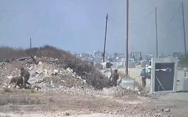 A screenshot of a video released by the IDF showing soldiers and members of a UN aid convoy taking cover during a mortar attack in central Gaza on June 25, 2024. twitter.com