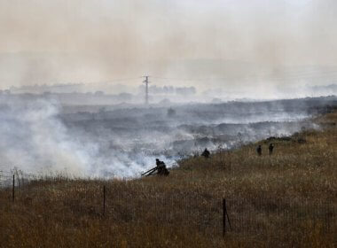 Israeli firefighters put out flames in a field after rockets launched from Lebanon struck the outskirts of Katzrin in the Golan Heights on June 2, 2024. AFP