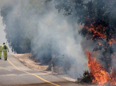 Israeli firefighters battle flames in a field in the Banias area of the Golan Heights sparked by rockets launched from southern Lebanon on June 9, 2024. AFP