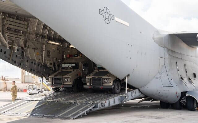 A plane with armored vehicles for the IDF arrives at Ben Gurion Airport, October 19, 2023. IDF