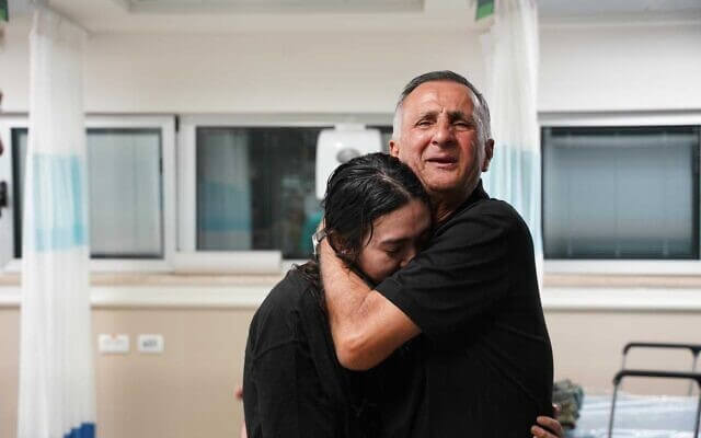 Noa Argamani is embraced by her father, Yaakov, at Sheba Medical Center after being rescued from Hamas captivity, June 8, 2024. IDF