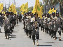 Supporters of Iraqi Hezbollah Brigades march in Baghdad, Iraq. AP