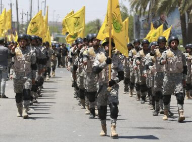 Supporters of Iraqi Hezbollah Brigades march in Baghdad, Iraq. AP