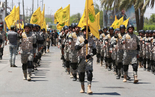 Supporters of Iraqi Hezbollah Brigades march in Baghdad, Iraq. AP