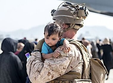 A Marine calms an infant during an evacuation at Hamid Karzai International Airport, Kabul, Afghanistan, Aug. 21, 2021. wnd.com