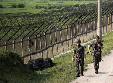 South Korean army soldiers patrol through the military wire fence in Paju. AP