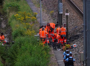 Railway staff and police work to repair one of several sites where vandals targeted France's high-speed train network, in the northern villege of Croisilles, on Friday. Reuters