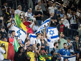 Supporters of Israel and Mali fly their flags at the men's group D soccer match. Olympic Committee of Israel
