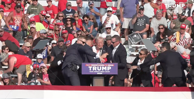 A bloodied former President Donald Trump is lifted from the podium floor after an assassination attempt. facebook.com