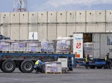 Trucks carrying humanitarian aid for the Gaza Strip pass through the inspection area at the Kerem Shalom Crossing in southern Israel, March 14, 2024. AP