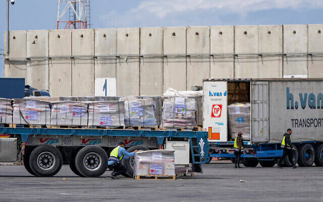 Trucks carrying humanitarian aid for the Gaza Strip pass through the inspection area at the Kerem Shalom Crossing in southern Israel, March 14, 2024. AP