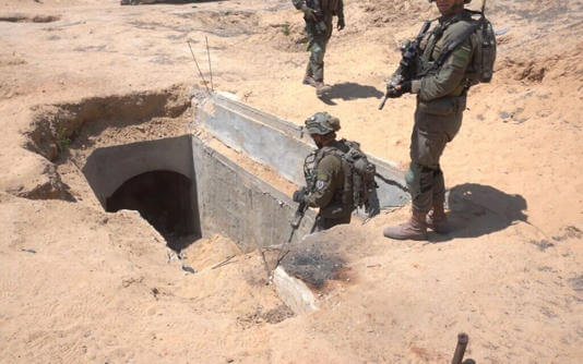 IDF troops stand at the entrance to an Islamic Jihad rocket manufacturing site in Rafah. IDF